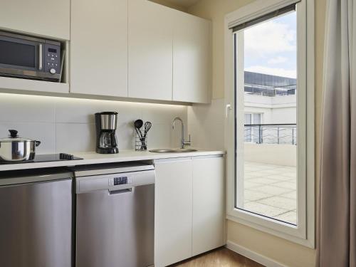 Kuchyň nebo kuchyňský kout v ubytování Aparthotel Adagio Porte de Versailles