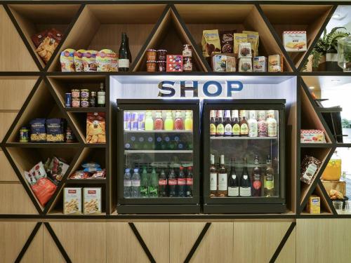a shop with a refrigerator filled with lots of drinks at Aparthotel Adagio Monaco Monte Cristo in Beausoleil