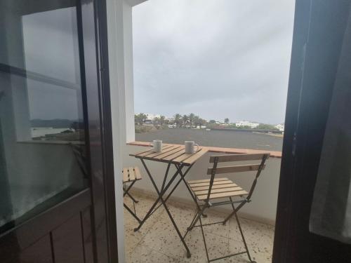 a table and a chair on a balcony with a view at Sabbia Suites Casa Vera in Teguise