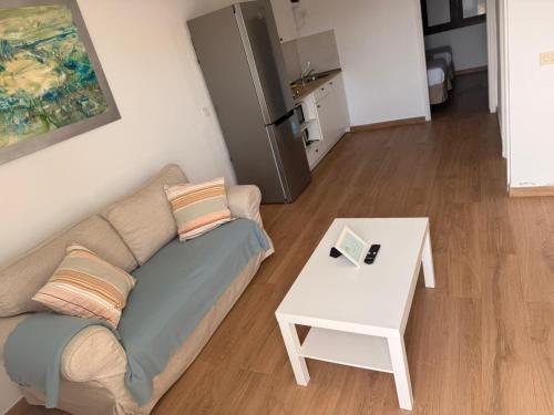 a living room with a couch and a table at Sabbia Suites Casa Vera in Teguise