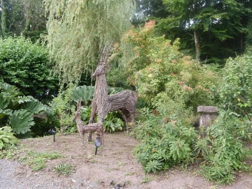 a garden with a statue of a tree at Brameley in Cheriton Bishop