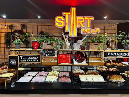a bakery with lots of cakes and pastries on display at Ibis Budget Oviedo in Oviedo