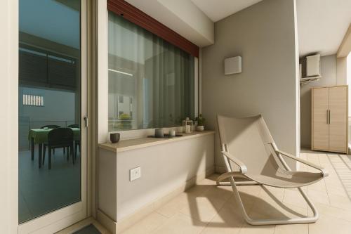 a chair in a living room with a table at LAKE VIEW 20 - free wi-fi - just 50 meters from the lake in Sarnico