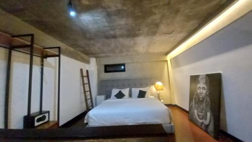 a bedroom with a bed and a mirror at Arzella Apartment in Seminyak