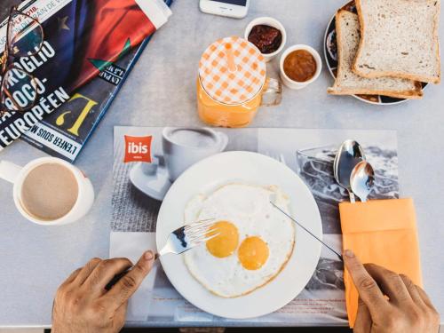 a table with a plate of eggs and toast at Ibis Tanger City Center in Tangier