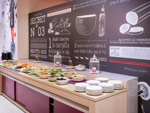 a buffet line with plates of food on it at Ibis Tanger City Center in Tangier