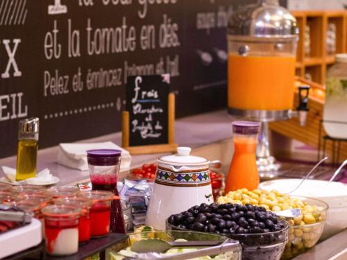 a table with a bunch of food on a counter at Ibis Tanger City Center in Tangier
