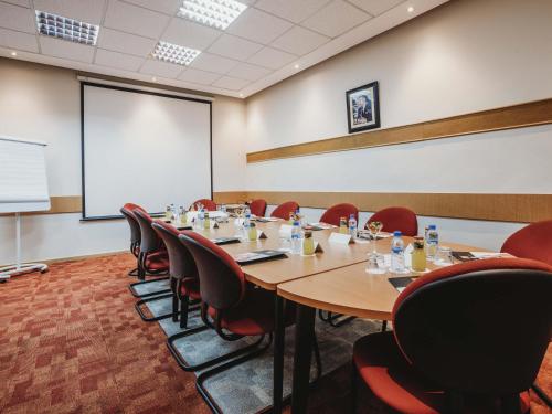 a conference room with a large table and chairs at Ibis Tanger City Center in Tangier