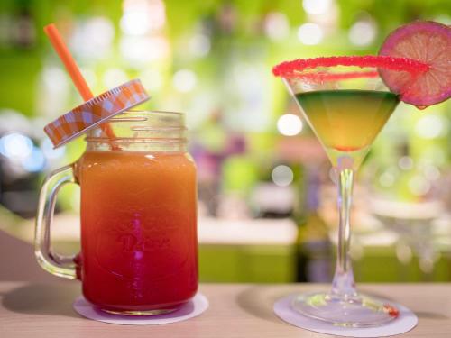a drink in a mason jar next to a drink at Ibis Tanger City Center in Tangier