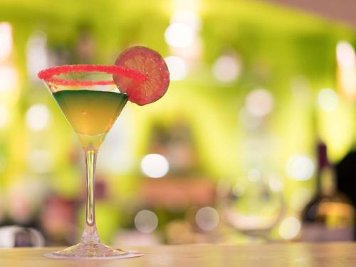 a drink with a strawberry on top of a table at Ibis Tanger City Center in Tangier