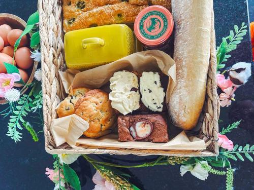 a basket filled with different types of pastries and bread at The Beaches in Berwick-Upon-Tweed