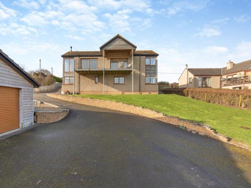 a house on a street with a driveway at The Beaches in Berwick-Upon-Tweed