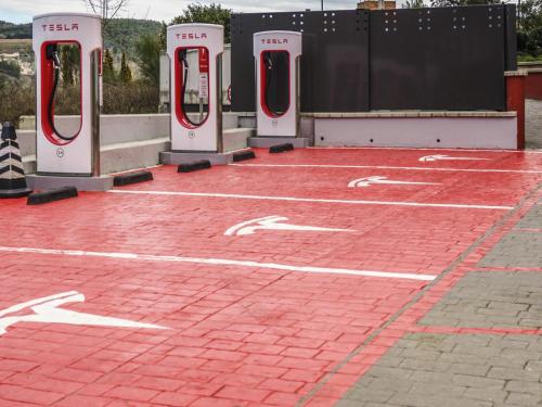 a parking lot with four red and white toilets at Ibis Girona in Girona