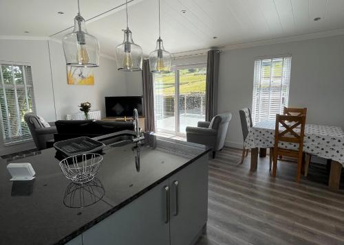 a kitchen and living room with a table and chairs at Bainbridge Ings in Hawes