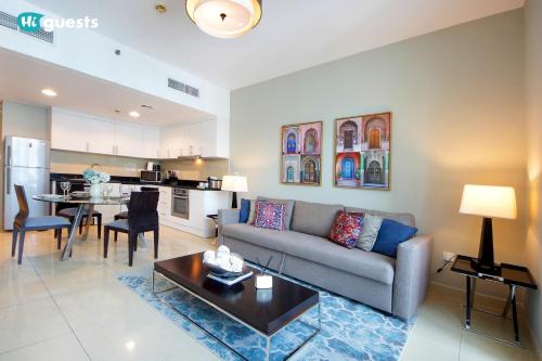 a living room with a couch and a table at HiGuests - Fabulous Duplex With Breathtaking Lake Views in Dubai