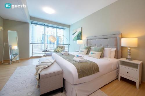 a bedroom with a large bed and a large window at HiGuests - Fabulous Duplex With Breathtaking Lake Views in Dubai