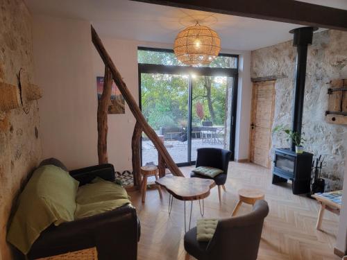a living room with a couch and a table at L'Alpage, vue lac in Brison-Saint-Innocent