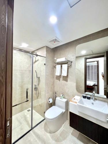 a bathroom with a toilet and a sink and a shower at Hoàng Huy Commerce Võ Nguyên Giáp Mopius Apartment in Hai Phong