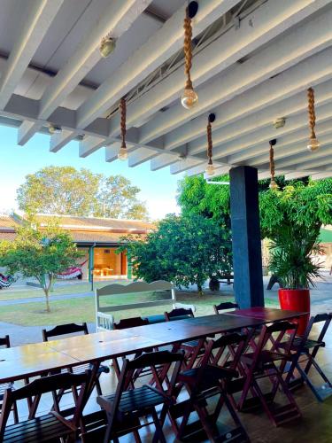 a group of tables and chairs in a patio at Pousada dos Nobres in Estivado