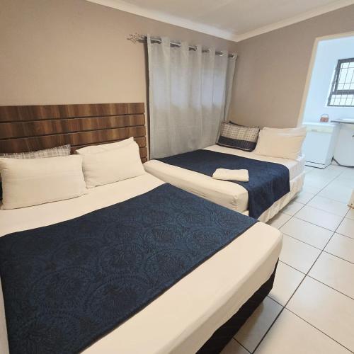 two beds in a hotel room withskirts at GALAXY BOSTON BELLVILLE in Cape Town