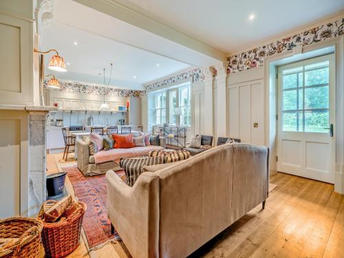 a living room with two couches and a fireplace at Uk47811 - Baillies Cottage in Kinloch Rannoch