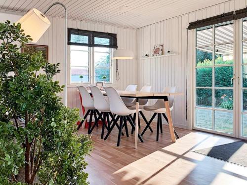a dining room with a table and white chairs at 7 person holiday home in Kirke Hyllinge-By Traum in Kirke-Hyllinge