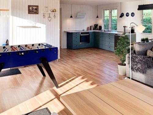 a kitchen with a blue table in the middle of a room at 7 person holiday home in Kirke Hyllinge-By Traum in Kirke-Hyllinge