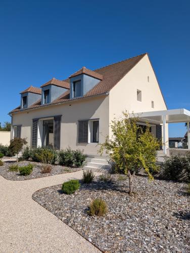 a large white house with a roof at Les Hôtes des Maillets 