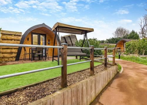 a childrens playground with a circular play structure at Peacock Lake Glamping in East Bridgford