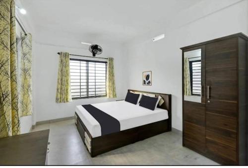 a bedroom with a large bed and a window at Hamai Grand Home Stay in Ambalavayal