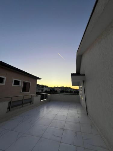 a balcony of a building with a sunset in the background at Miri House in Domje