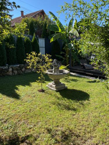 a garden with a statue in the grass at Vasilija in Sremski Karlovci