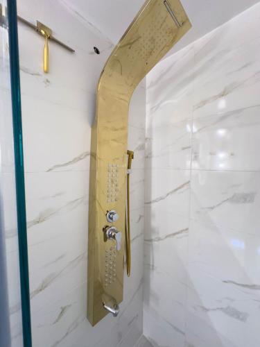 a shower in a bathroom with white marble walls at Top views, airport, Salitre, American embassy, parking in Bogotá