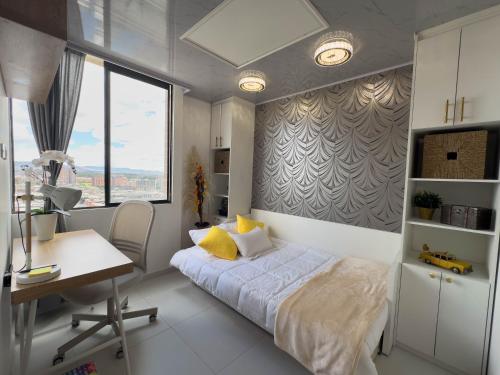 a bedroom with a bed and a desk and a deskablish at Top views, airport, Salitre, American embassy, parking in Bogotá