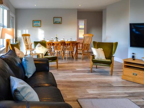 a living room with a couch and chairs and a table at Clarksburn Blue in Monreith