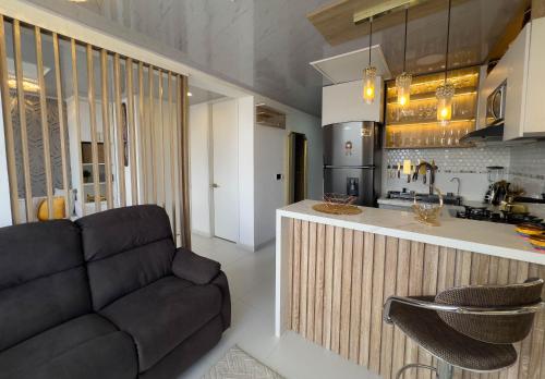 a living room with a couch and a kitchen at Top views, airport, Salitre, American embassy, parking in Bogotá