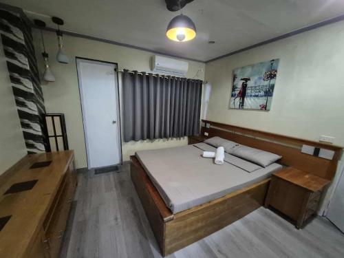 a bedroom with a large bed and a window at 2 separate fully furnished condo units 1BR on the 23rd flr and 3BR penthouse on the 41st flr, with different bookings and daily rates in Ermita, Manila near SLEC,US Embassy, Mall and Parks in Manila
