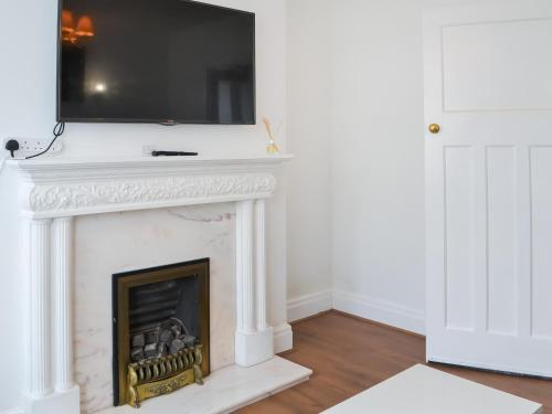 a fireplace with a television on top of it at Rose And Jay House in Bridlington