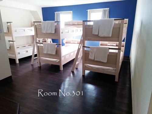 a group of bunk beds in a room at Ace Inn Asakusa in Tokyo