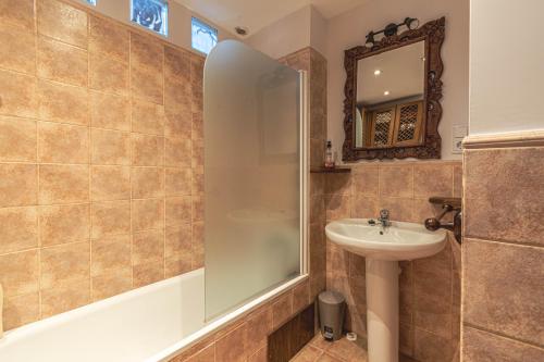 a bathroom with a shower and a sink at House with garden and fireplace in Osséja