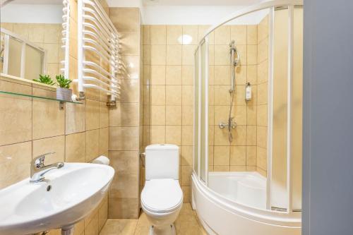 a bathroom with a toilet and a sink and a shower at Hotel Polonia Centrum in Wrocław