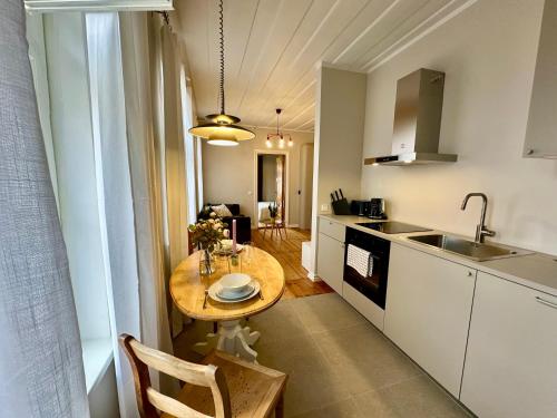 a small kitchen with a table and a sink at Apartment in the centre of Viljandi in Viljandi