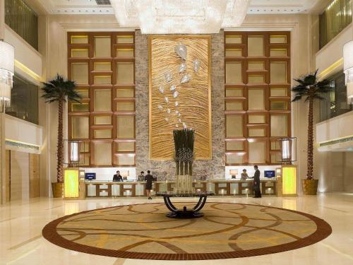 a lobby with a fountain in the middle of a building at Sofitel Harbin in Harbin