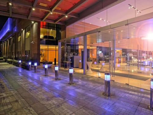 a building with a bunch of lights in front of it at Novotel Pune Viman Nagar Road in Pune