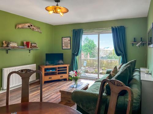 a living room with a couch and a table at Flodden Apartment in Wooler