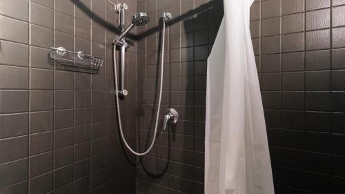 a shower with a white shower curtain in a bathroom at Italianway - Tadino 1 B in Milan