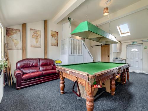 a room with a pool table and a couch at Greystones Nawab Annex C in Monyash