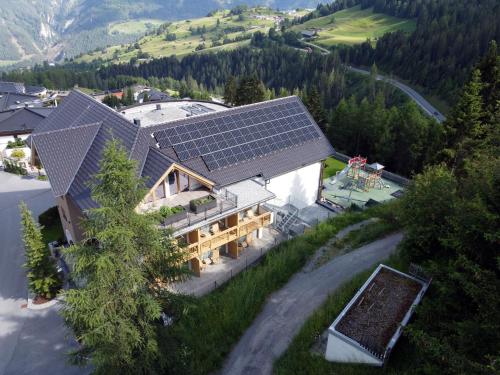 an aerial view of a house with solar panels on the roof at Natürlich Hotel mit Charakter in Fiss