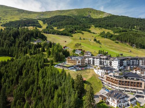 an aerial view of a resort in the mountains at Natürlich Hotel mit Charakter in Fiss