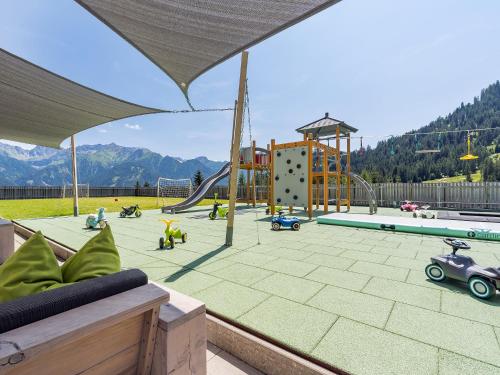 a playground with a slide and toy cars on it at Natürlich Hotel mit Charakter in Fiss